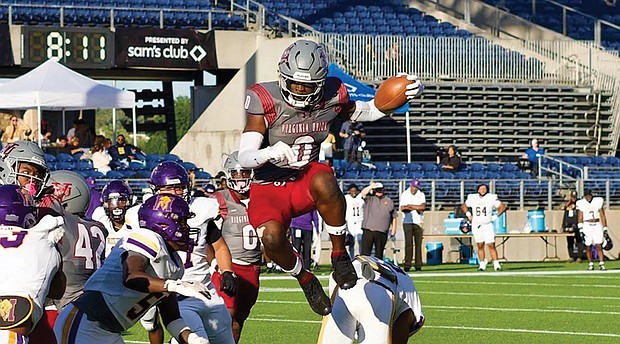 Virginia Union running back Curtis Allen (0) leaps over defenders during the Panthers’ 45-3 win over Miles College in the Black College Football Hall of Fame Classic on Sunday at Tom Benson Hall of Fame Stadium in Canton, OH.