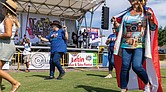 Abigail Holliday line dances to the “Salsa Slide” while wearing a Puerto Rican flag at the event.