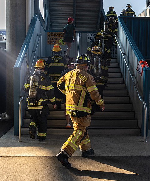 Firefighters climb stairs during the Metro Richmond 9/11 Memorial Stair Climb at Richmond Raceway on Saturday,Sept. 6.