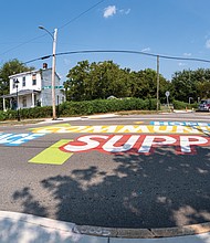 A colorful mural covers the intersection of 27th Street and Nine Mile Road in Church Hill. The street-level installation, located near Bon Secours Urgent Care and the Sarah Garland Jones Center, incorporates local culture and history.