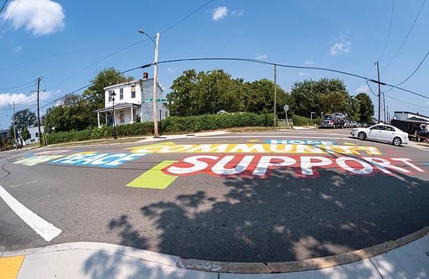 A colorful mural covers the intersection of 27th Street and Nine Mile Road in Church Hill. The street-level installation, located near Bon Secours Urgent Care and the Sarah Garland Jones Center, incorporates local culture and history.