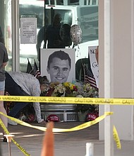 Well-wishers pay their respects at a makeshift memorial for Charlie Kirk at the national headquarters of Turning Point USA in Phoenix, Arizona, after Kirk was killed Wednesday.
Mandatory Credit:	Ross D. Franklin/AP via CNN Newsource