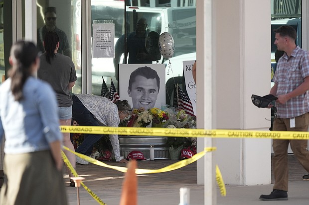 Well-wishers pay their respects at a makeshift memorial for Charlie Kirk at the national headquarters of Turning Point USA in Phoenix, Arizona, after Kirk was killed Wednesday.
Mandatory Credit:	Ross D. Franklin/AP via CNN Newsource