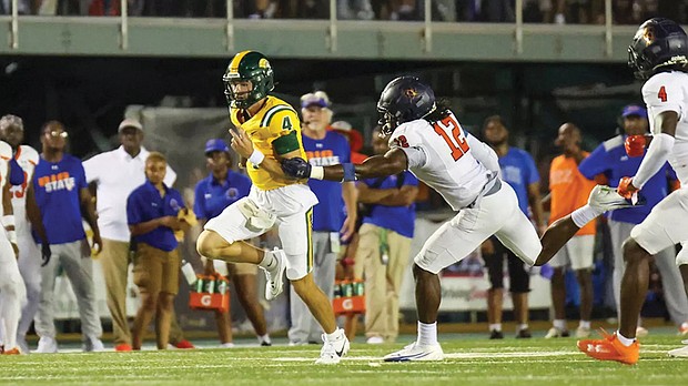 Norfolk State’s quarterback Otto Kuhns (#4) sprints downfield as Virginia State’s Mehkhi Johnson (#12) gives chase during Saturday’s 34-31 overtime win at William “Dick” Price Stadium.
