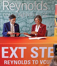 Virginia Commonwealth University President Michael Rao and Reynolds Community College President Paula Pando sign documents Tuesday, Sept. 8 to launch NEXT Step VCU, a dual-admission program that helps eligible community college students transfer to VCU. The first group will include about 50 to 100 students, with plans to grow in future years.