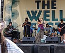 Vocalist Sam Reed performs at The WELL Fest outside of Main Street Station.