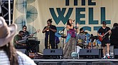 Vocalist Sam Reed performs at The WELL Fest outside of Main Street Station.
