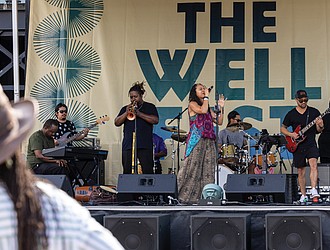 Vocalist Sam Reed performs at The WELL Fest outside of Main Street Station.