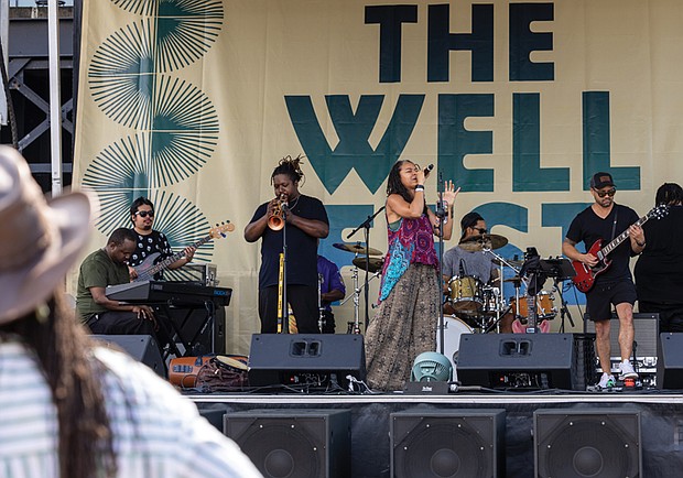 Vocalist Sam Reed performs at The WELL Fest outside of Main Street Station.