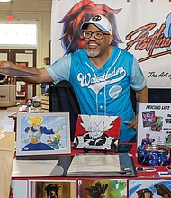 Richmond comic artist Will Watkins sells and signs artwork for a customer during the ComiCon. The artist is known for his dynamic digital illustrations and vibrant character designs.