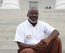 Sam Harris sits on the steps of the Virginia State Capitol, where a change in state law allowed him to earn early release and co-found a nonprofit that helps people navigate reentry after prison.