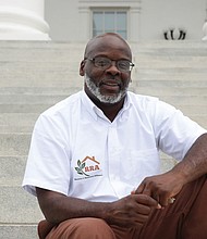 Sam Harris sits on the steps of the Virginia State Capitol, where a change in state law allowed him to earn early release and co-found a nonprofit that helps people navigate reentry after prison.