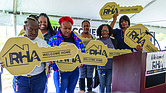 Returning residents of Creighton Court received symbolic keys to their new homes Tuesday, Sept. 16, from Victor Branch, Richmond market president for Bank of America, during the a ceremony, that also announced the community’s new name, Creighton Renaissance.