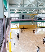 Cityscape-Slices of life and scenes in Richmond-Community members explore the indoor basketball courts at the newly opened Lucks Field Community Center in Richmond’s East End. The $20 million center was funded with American Rescue Plan Act dollars. The 30,000-square-foot facility includes a teaching kitchen, gymnasium, rooftop basketball court, playground, fitness equipment and a refurbished outdoor basketball court. It can also serve as an emergency response site, providing shelter during severe weather or a central location for vaccine distribution during a pandemic. (Julianne Tripp-Hillian)
