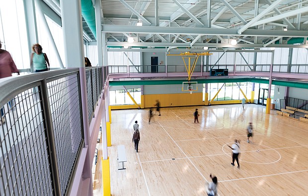 Cityscape-Slices of life and scenes in Richmond-Community members explore the indoor basketball courts at the newly opened Lucks Field Community Center in Richmond’s East End. The $20 million center was funded with American Rescue Plan Act dollars. The 30,000-square-foot facility includes a teaching kitchen, gymnasium, rooftop basketball court, playground, fitness equipment and a refurbished outdoor basketball court. It can also serve as an emergency response site, providing shelter during severe weather or a central location for vaccine distribution during a pandemic. (Julianne Tripp-Hillian)