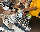Volunteers hand out food to guests at Ephesus Community Service on Sept. 9.