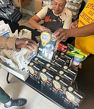 Volunteers hand out food to guests at Ephesus Community Service on Sept. 9.