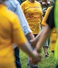 Naimahya Boyd, a Virginia Commonwealth University student from Maryland, waves peace dove puppets and sings during the Global Sing for Unity at Byrd Park on Sunday, Sept. 21, as part of PeaceFest 2025. Richmonders join hands during the “Dances of Universal Peace” at Byrd Park on Sunday, Sept. 21 as part of the event. The gathering was followed by a “Global Sing for Unity” and a march to Carytown.