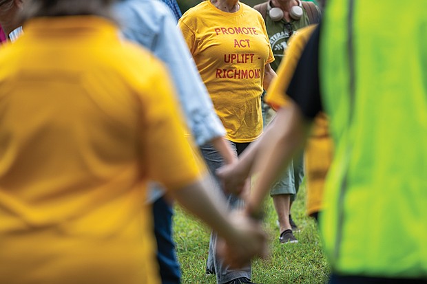 Naimahya Boyd, a Virginia Commonwealth University student from Maryland, waves peace dove puppets and sings during the Global Sing for Unity at Byrd Park on Sunday, Sept. 21, as part of PeaceFest 2025. Richmonders join hands during the “Dances of Universal Peace” at Byrd Park on Sunday, Sept. 21 as part of the event. The gathering was followed by a “Global Sing for Unity” and a march to Carytown.
