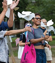 Naimahya Boyd, a Virginia Commonwealth University student from Maryland, waves peace dove puppets and sings during the Global Sing for Unity at Byrd Park on Sunday, Sept. 21, as part of PeaceFest 2025. Richmonders join hands during the “Dances of Universal Peace” at Byrd Park
on Sunday, Sept. 21 as part of the event. The gathering was followed by a “Global Sing for Unity” and a march to Carytown.