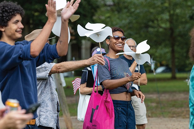 Naimahya Boyd, a Virginia Commonwealth University student from Maryland, waves peace dove puppets and sings during the Global Sing for Unity at Byrd Park on Sunday, Sept. 21, as part of PeaceFest 2025. Richmonders join hands during the “Dances of Universal Peace” at Byrd Park
on Sunday, Sept. 21 as part of the event. The gathering was followed by a “Global Sing for Unity” and a march to Carytown.