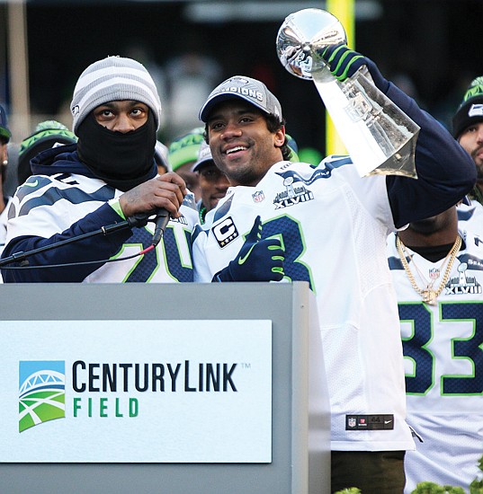 Russell Wilson holds the Lombardi Trophy at CenturyLink Field. Wilson won the 2014 Super Bowl with Seattle and has embarked upon his 14th NFL season. He became the first Black quarterback in New York Giants history
to start a season opener and was recently named the National Black Players Coalition’s “Quarterback of the Century” for his on- and off-field achievements.