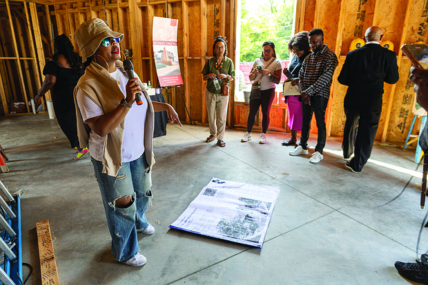 Cityscape Slices of life and scenes in Richmond-JXN Project Executive Director Sesha Joi Moon welcomed guests to the nonprofit’s
dedication day Saturday, Sept. 21, at the JXN Haus and Skipwith-Roper Cottage. During the event, community members wrote well wishes on the building’s framing and contributed notes for a time capsule to be buried on the property. The JXN Project aims to contextualize
the origins of the Jackson Ward neighborhood. Once a thriving center of Black economic and political life, Jackson Ward was transformed by the construction of the Richmond-Petersburg Turnpike in
the 1950s, which displaced more than 1,000 families, including the last Black homeowners of the Skipwith-Roper Cottage. Research revealed that the cottage was relocated rather than destroyed, and remnants of the original structure still exist. The restored Skipwith-Roper Cottage and JXN Haus will serve as a multifunctional space for research and community programming.(Julianne Tripp/Hillian/Richmond Free Press)