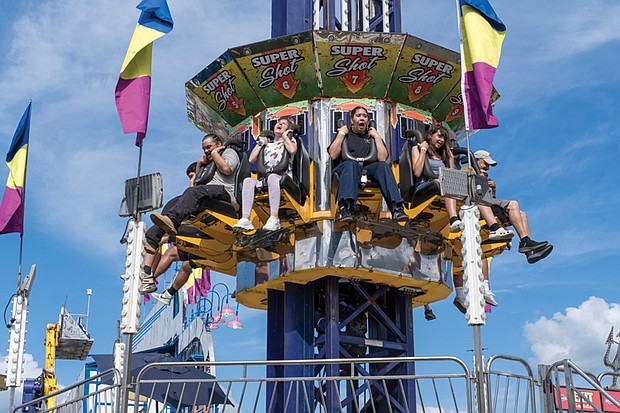 State of fun The State Fair of Virginia returned to The Meadow Event Park in Doswell last weekend,drawing crowds from across the Commonwealth and beyond. Fairgoers packed the midway, sampling food from vendors, testing their luck at carnival games and taking in the rides. The fair, which opened Sept. 26, continues through Oct. 5. Riders plummet from the Super Shot as thousands from across Virginia and elsewhere
gather at the State Fair of Virginia in Doswell for food, games and thrilling rides.