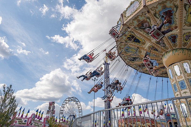 State of fun
The State Fair of Virginia returned to The Meadow Event Park in Doswell last weekend, drawing crowds from across the Commonwealth and beyond.
Fairgoers packed the midway, sampling food from vendors, testing their luck at carnival games and taking in the rides. The fair, which
opened Sept. 26, continues through Oct. 5. Fair skies-Riders soar on the Wave Swinger at the State Fair of Virginia in Doswell, where thousands from across the state gather for food, games and rides. (Sandra Sellars/Richmond Free Press)