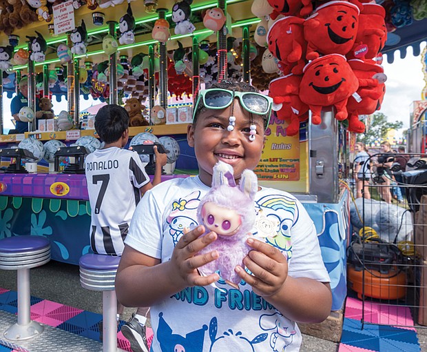 State of fun-The State Fair of Virginia returned to The Meadow Event Park in Doswell last weekend,drawing crowds from across the Commonwealth and beyond. Fairgoers packed the midway, sampling food from vendors, testing their luck at carnival games and taking in the rides. The fair, which opened Sept. 26, continues through Oct. 5. A delighted Sariyah Davis wins A Labubu doll, one of the popular collectible toys created by Hong Kong artist Kasing Lung that have become a global phenomenon. (Sandra Sellars/Richmond Free Press)