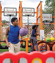 A young man dribbles a basketball during “Falling for the Culture: A Festival of Unity, Peace, and Hope” on Sunday in Jackson Ward.