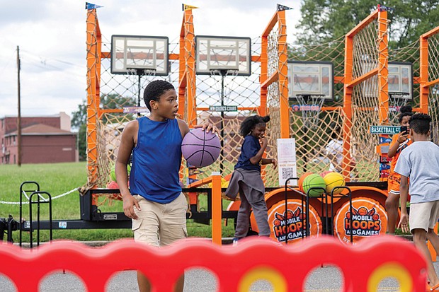 A young man dribbles a basketball during “Falling for the Culture: A Festival of Unity, Peace, and Hope” on Sunday in Jackson Ward.