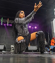 Pride in full color
Virginia PrideFest 2025 drew crowds to Midtown
Green on West Leigh Street on Saturday, Sept. 27, concluding a week of events organized by VA Pride. The festival featured all-day performances on two stages, along with vendors offering food and drinks.
Melanin Monroe commands the main stage at Virginia PrideFest.
Monroe also co-hosted the evening’s performances with Nellyfresh. (Julianne Tripp Hillian/Richmond Free Press)