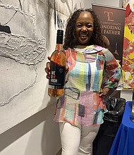 Chrishon Lampley, owner of Love Cork Screw, did a wine tasting at the Village Legal and Community Project fundraising gala. Photo by Tia Carol Jones.
