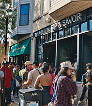 During the MALIKSHOTYOU ArtWalk in Bronzeville participants were encouraged to support local Black owned businesses. Photo by Gerard Ortiz & Brittany Banko: VYBE Media.