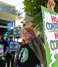 Judith Vought, a Starbucks barista, joins a practice picket Oct. 4 outside the Starbucks at 3555 W. Cary St. The demonstration was part of a national wave of pickets in 35 cities following announcements of store closures and layoffs. Baristas are calling on Starbucks to finalize a contract with improved staffing, hours, pay and workplace protections.