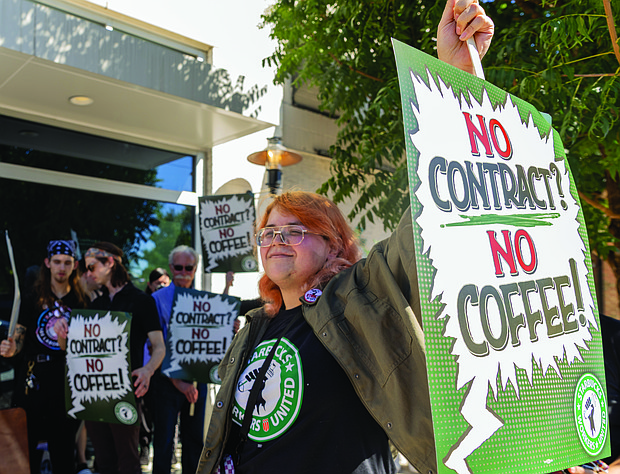 Judith Vought, a Starbucks barista, joins a practice picket Oct. 4 outside the Starbucks at 3555 W. Cary St. The demonstration was part of a national wave of pickets in 35 cities following announcements of store closures and layoffs. Baristas are calling on Starbucks to finalize a contract with improved staffing, hours, pay and workplace protections.