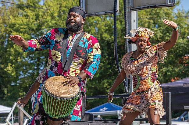 Fun first at Second Street Festival-Dancer Mayah Walker Taylor, right, and drummer Zion Utsey, left, of Ezibu Muntu perform on the Eggleston Hotel Community Stage on Saturday, Oct. 4, during the annual 2nd Street Festival in Jackson Ward. (Julianne Tripp Hillian/Richmond Free Press)