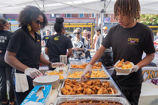 Fun first at Second-Street Festival-The 2nd Street Festival marked its 37th anniversary Oct. 4-5, filling Richmond’s historic Jackson Ward with music, food and community spirit. The annual event celebrates the culture and legacy of Jackson Ward — once known as “the Harlem of the South” — and the neighborhood’s role as the heart of Richmond’s Black community. The free festival featured three stages of live entertainment, a Kidz Zone, food vendors, an Artists Row, and a marketplace showcasing local talent and craftsmanship. Brianna Royal and Davin Washington Jr. serve fried treats to a long line of customers at the Croaker’s Spot tent. (Julianne Tripp Hillian/Richmond Free Press)