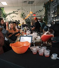 Food as Function-The local food scene took center stage at The Function, a barbecue and fish fry at Charlotte’s Southern Deli celebrating Virginia’s culinary heritage and the talents of Black chefs. Organized by Charlotte’s owners Nikki Gregory and Paul Polk with local food writer James L. Ford III, the event showcased Southern traditions reimagined by some of the area’s most creative culinary voices. Jason Muckle mixed cocktails at
Charlotte’s Southern Deli.