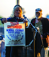 Honoring the Lost-On Oct. 2, 1925, a 200-foot section of Richmond’s Church Hill Tunnel collapsed during a railway upgrade, burying a work train and killing at least four men. Two laborers were never recovered, and the tunnel was later sealed, leaving the site unstable. On Oct. 2, the Friends of Jefferson Park and the Church Hill Association held a commemoration
to honor those lost and mark a century since the tragedy. Richard Lee Bland and Bob Harrison, organizers of the 100th anniversary of the Church Hill Tunnel collapse, share a poster and reflect on their experiences.(Julianne Tripp Hillian/Richmond Free Press)