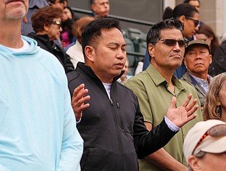 Worshippers reflect during the praise and worship service at Catholic Fest, held Oct. 11 at The Diamond.
