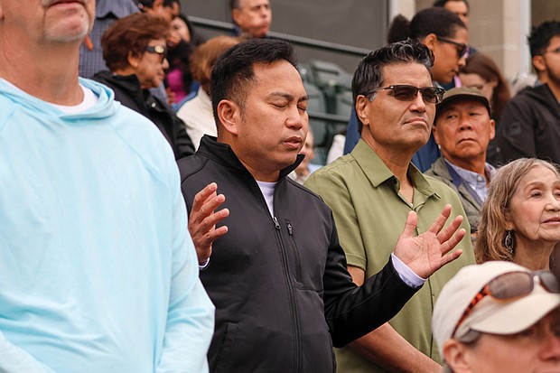 Worshippers reflect during the praise and worship service at Catholic Fest, held Oct. 11 at The Diamond.