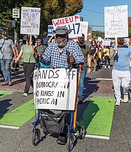 Robert Barr, 77, of Caroline County, marches with thousands of protesters down Belvidere Street toward Monroe Park during the No Kings demonstration Oct. 18.