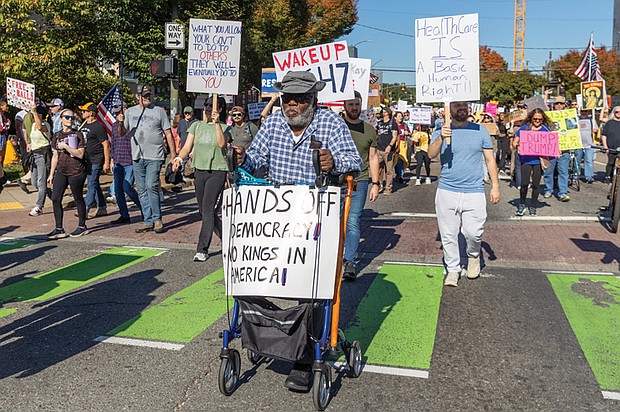 Robert Barr, 77, of Caroline County, marches with thousands of protesters down Belvidere Street toward Monroe Park during the No Kings demonstration Oct. 18.