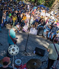 Thousands gather in Monroe Park in Richmond after marching down Broad Street from Capitol Square during the No Kings demonstration, where the event continued with musical performances and speeches. (Julianne Tripp Hillian/Richmond Free Press)