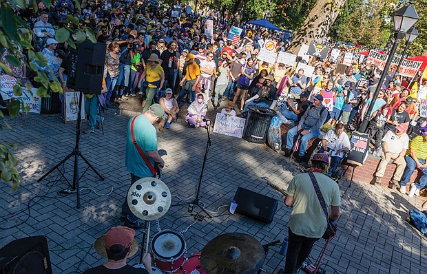 Thousands gather in Monroe Park in Richmond after marching down Broad Street from Capitol Square during the No Kings demonstration, where the event continued with musical performances and speeches. (Julianne Tripp Hillian/Richmond Free Press)