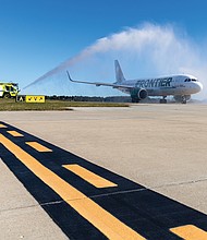 Cityscape-Slices of life and scenes in Richmond-A Frontier Airlines flight from Hartsfield-Jackson Atlanta International Airport passes through a ceremonial water arch after landing at Richmond International Airport on Oct. 21. The arrival marked Frontier’s first passenger flight to Richmond and the start of new nonstop service between the two cities. Airport officials said the addition of Frontier expands travel options for Central Virginia passengers and strengthens connections to major hubs in the South and West. The airline has also added new nonstop service from Richmond to Denver. (Julianne Tripp Hillian/Richmond Free Press)