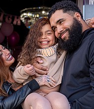 Myla poses with her parents, Kristen Lux and James Freeman, following her confidence-restoring makeover at Bombshell Wigs Galore in Midlothian. The event was held in recognition of Cancer Awareness Month.