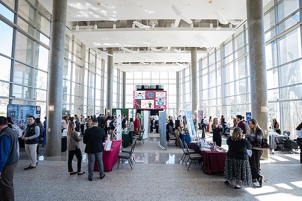 Students interact with business representatives during the HMGT Career Fair on Thursday, Mar 20, 2025 in College Station, Texas. (Hannah Harrison/Texas A&M AgriLife)